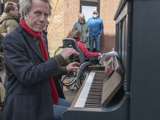 Man speelt piano op straat bij Living History Appingedam.